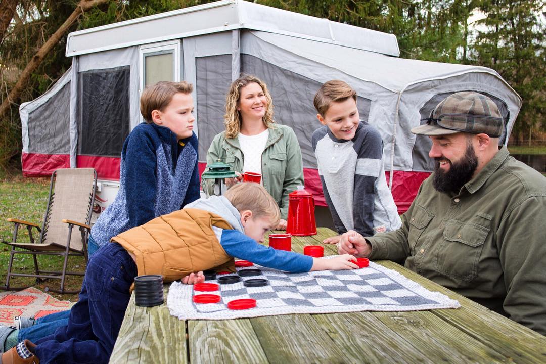 The Puglisis enjoying some family time outside their camper.