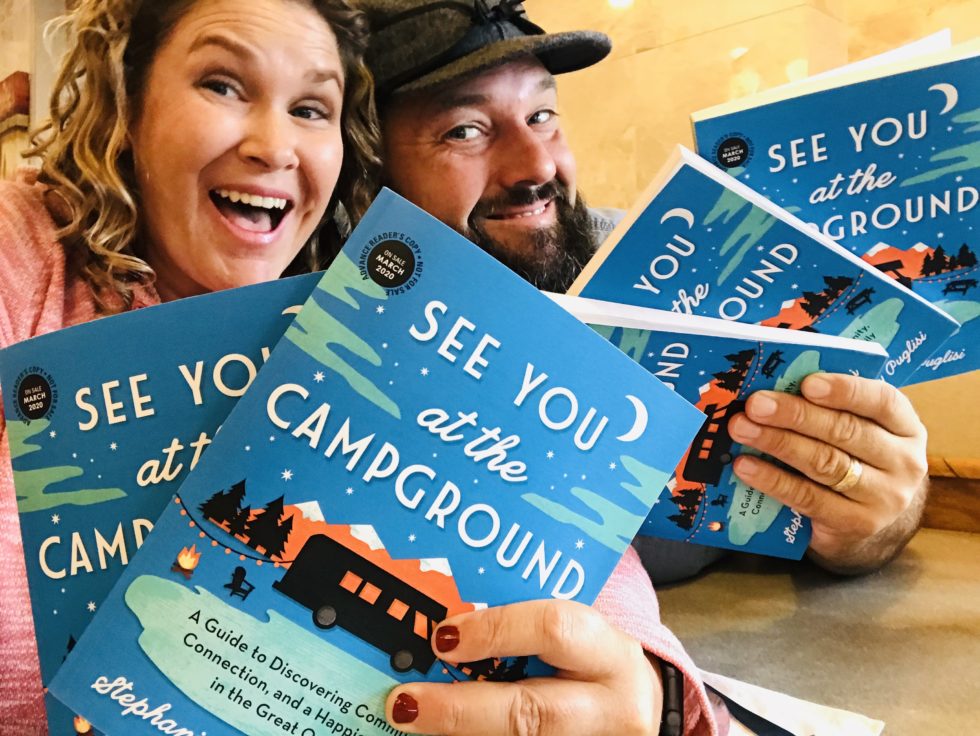 Stephanie and Jeremy Puglisi holding their book.